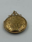 A 9ct gold locket with floral decoration approximate total weight 8.1g