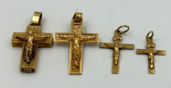 A selection of four differing 9ct yellow gold crucifix pendants with an approximate weight of 9.3g