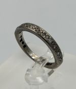 An 18ct white gold half eternity ring with an approximate size of L and weight 3.6g