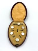 A boxed set of shirt studs, with other of pearl centers.