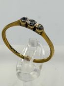 An 18ct gold and platinum three stone diamond ring with an approximate weight of 1.6g and size O