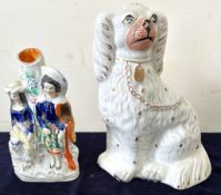A Staffordshire spill vase and a Staffordshire Spaniel dog