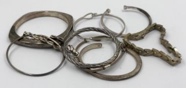 A selection of silver bangles in varying styles, approximate weight of 140g