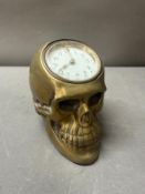 A brass desk top in the form of a skull