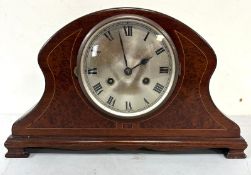 A mahogany mantel clock in a Napoleon hat style
