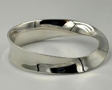 A Georg Jensen silver bangle, with twisted design approximate weight 53g and approximate width 76mm