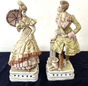 A pair of Italian porcelain figurines depicting a 19th Century courting couple