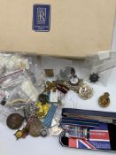 A selection of military cap badges and insignia, various regiments and conditions.