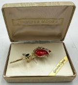 A red enamel rose brooch pin featuring genuine crystal accents by Jennifer Moore