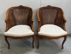 A pair of Louis style wicker open arm chairs on cabriole legs. One AF Height 84cm x 61 width, seat