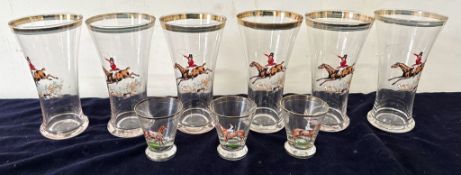 Six cocktail drinking glasses and four shot glasses with gold trim and traditional fox hunting and