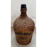 A green glass Carafe in a wicker jacket