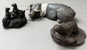 Three ornaments, otters and a pig