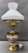 A brass table lamp with ceramic bowl