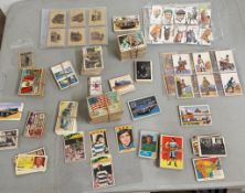 A collection consisting of various vintage cigarette and trade cards featuring subjects like