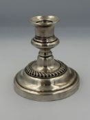 A silverplated squat, filled candlestick approximate height 10.5cm.