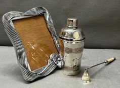 A mixed metal lot to include a cocktail shaker, candle snuffer anf photo frame