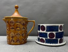 A Portmerian totem pattern lidded jug together with a Portmerian Talisman pattern cheese dome and
