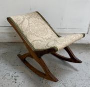 An oak gout stool with cream upholstery