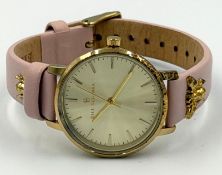 A Bill Skinner Bee watch with pink leather strap.
