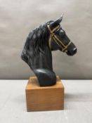 A bronze effect bust of a horse on plinth