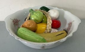 A wash bowl and china fruit