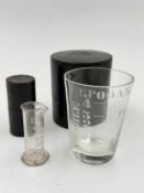 Two antique pharmacy glass measures in original leather boxes.