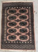 A wool prayer mat, pink grounds with geometric border