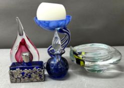 A selection of decorative glass items, including a perfume bottle and a bowl
