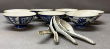 A selection of blue and white Chinese bowls and spoon