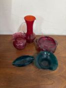 A small collection of decorative glassware to include three bowls and two red pitchers
