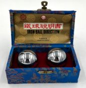 A set of Baoding balls in a blue box with traditional Chinese pattern