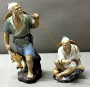 A pair of porcelain vintage Chinese Mudmen figurines, likely crafted in china