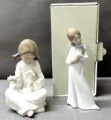 A pair of Nao porcelain figurines one girl with dog and one time for your bottle featuring a young