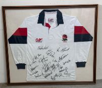 A framed England rugby shirt signed by members of the England rugby team including Martin Johnson