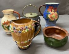 A collection of vintage jugs and biscuit barrels, including Royal Doulton