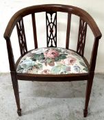A mahogany tub chair with a floral upholstered seat with tapered legs H75cm W53cm D46cm