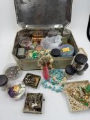 A tin of vintage beads, rhinestone assorted necklaces and other sewing items