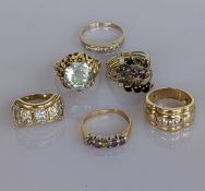 Four gem-set rings on yellow gold settings, all stamped 585, 18.75g, together with a yellow gold sta