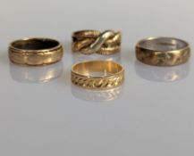 A 18ct yellow gold band with etched decoration, size I, 2.4g and three other gold rings
