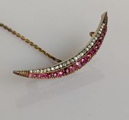 A Victorian ruby and diamond crescent brooch, unmarked, tests for 14ct gold, 46mm W, with fitted box
