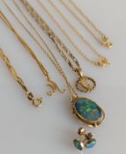 An Australian oval fire opal pendant yellow gold chain, stone 18 x 12mm, and matching earrings