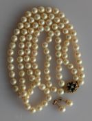 A two row cultured pearl choker with a 9ct yellow gold clasp, hallmarked, with sapphire and seed pea
