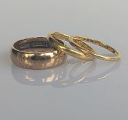 Three yellow gold wedding bands: one in 9ct, mm, 4.5g; 18ct, 1.65g, 1mm and 22ct, 2.3g, 2mm
