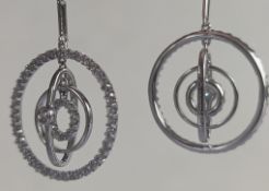 A pair of Iliana floating diamond drop earrings on a white gold setting, hallmarked 18ct, 6.7g
