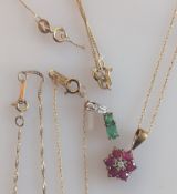 A garnet flower pendant gold chain, clasp good, another emerald set gold pendant and a selection 