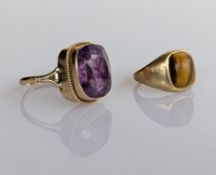 A amethyst set dressing ring and a tiger eye set ring, both set in 9ct yellow gold, hallmarked, size