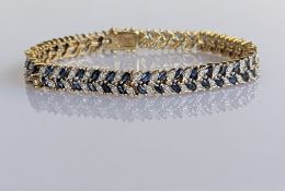A sapphire and diamond decorated bracelet on a yellow gold setting, approximate diamond weight 1.65