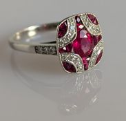 An Art Deco ruby and diamond dress ring on a platinum setting, the central cushion-cut ruby