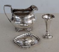 A George III silver creamer  with carved decoration to rim and handle, on a raised base, London, 181